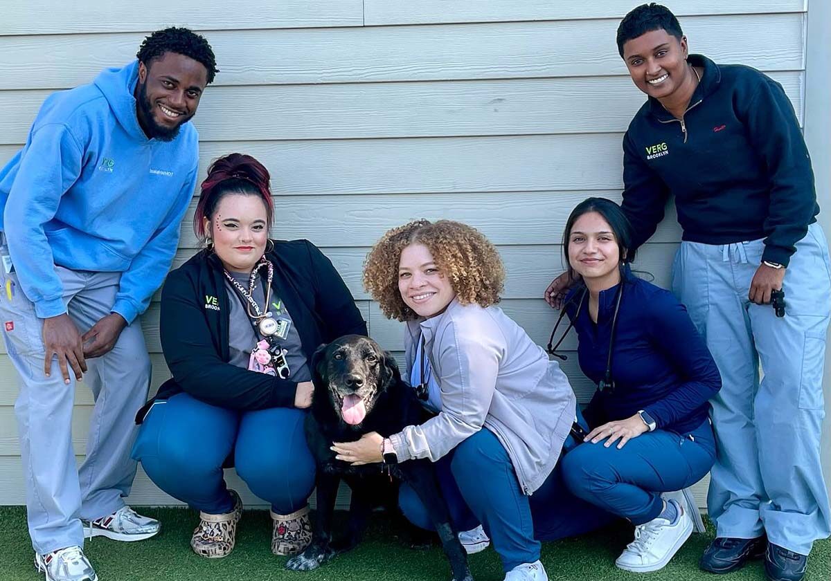 members of our team posing for a photo outside the building