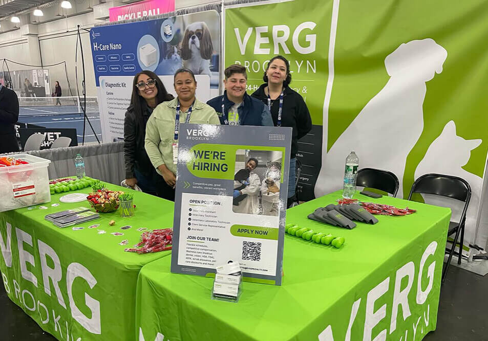 VERG team posing behind VERG tradeshow booth